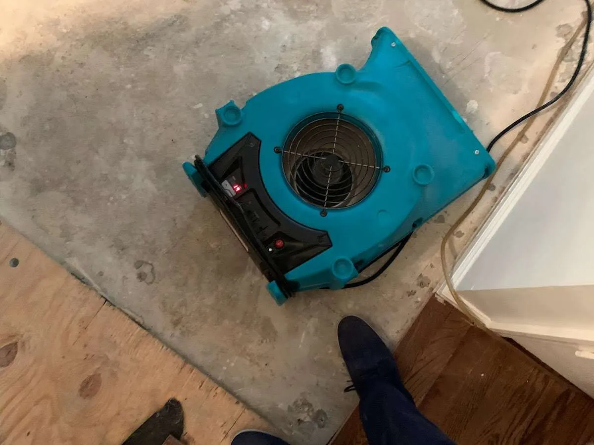 Air mover drying subfloor during Commercial Water Damage Restoration in Wells